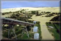 Coffin Bay limesand deposit, viewed from the top of the storage bin, showing conveyor, hopper, workshop, electric shovel and limesand dunes