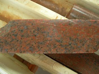 Figure 2a Moderately hematite-altered tonalite, 1,465 m. Drill core is 3.5 cm wide. (Photo 415922)