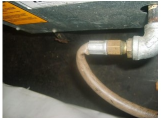 Figure G 8: Example of a damaged gas hose on a temporary cooking setup at an outside event Photo of a damaged gas hose on a temporary cooking setup at an outside event