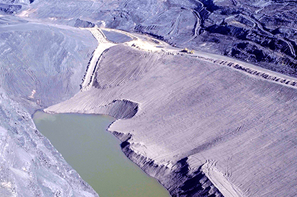 Figure 4 Aerial view of part of the Main Series pit showing drop-structure channels (top left) designed to capture and direct surface water runoff to minimise disturbance of rehabilitated slopes. (Courtesy of Flinders Power; photo 416241) Figure 4 Aerial view of part of the Main Series pit showing drop-structure channels (top left) designed to capture and direct surface water runoff to minimise disturbance of rehabilitated slopes. (Courtesy of Flinders Power; photo 416241)
