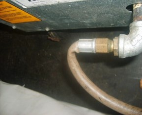 Photo showing a damaged gas hose on a temporary cooking setup at an outside event