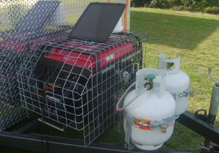 Photo shows a non-compliant portable generators next to two white gas cylinders. 