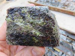Figure 5f Intense epidote–quartz alteration and chalcopyrite within the granodiorite from drill core.